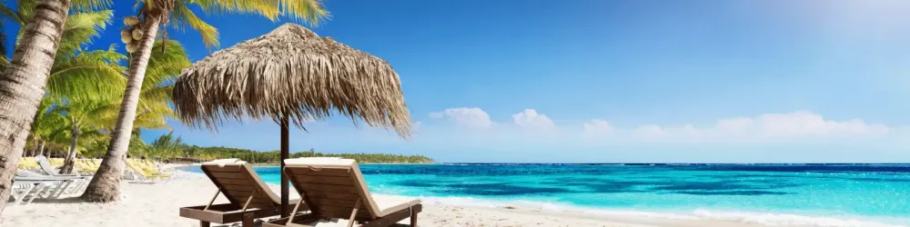 Caribbean Palm Beach With Wooden Chairs And Straw Umbrella - Idyllic Island
